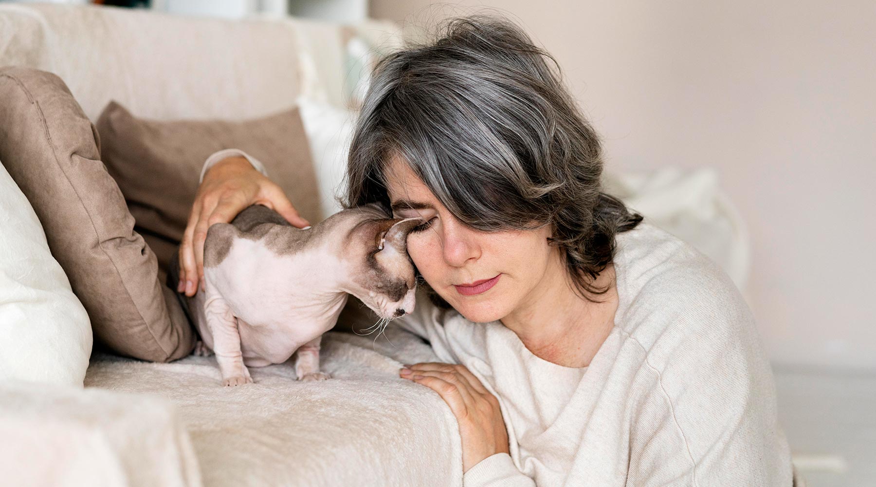 woman-sharing-quiet-loving-moment-with-her-cat-at-home-1800x1000-1